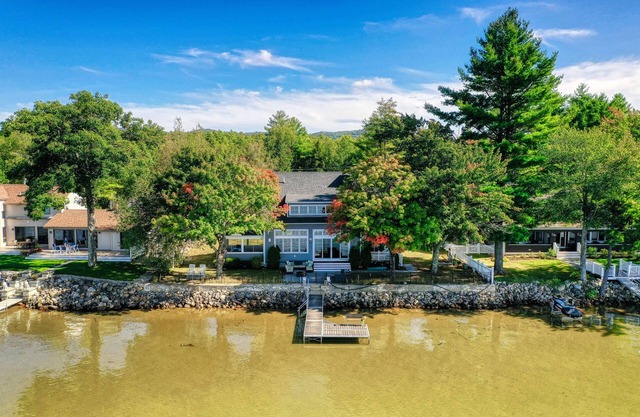 Dog-friendly lakefront home with lake views, firepit, dock, patio, & grill