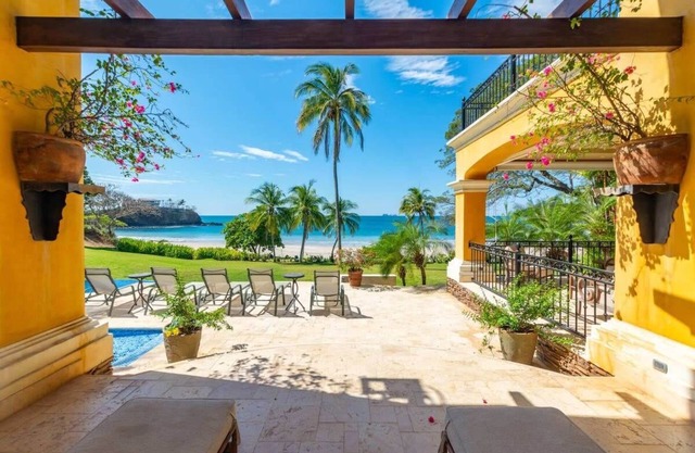 Elegant Mediterranean-Style Mansion with Beachfront Views and Private Infinity P