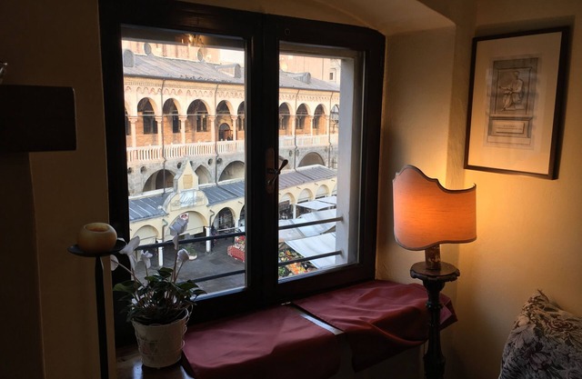 Elegant two-story apartment with windows overlooking the Palace of Reason.