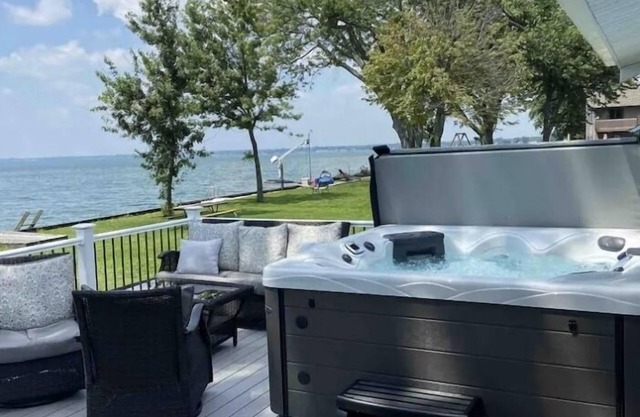 Enjoy Beautiful Sunsets at this Lake House w a HOT TUB, Boat Garage and Game Rm