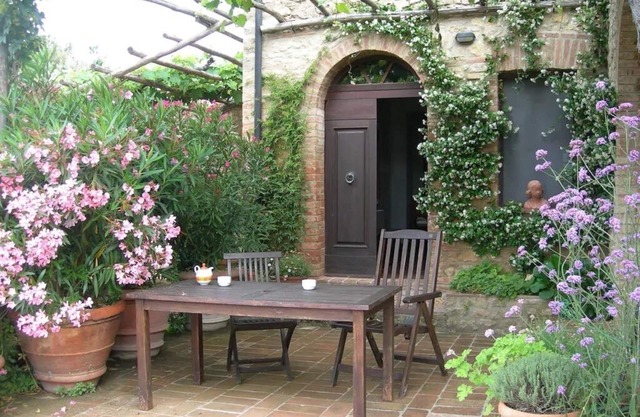 Farmhouse from 17th century with antique furniture and many flowers.