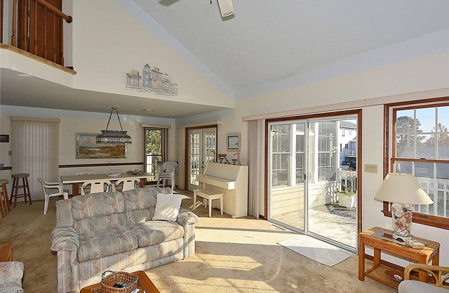 FREE DAILY ACTIVITIES! Lovely 4 bedroom + Den, (Two Master Bedrooms) 3.5 bath home, located on the canal, with boat dock, 2 car garage,just a short walk to the lifequarded beach.