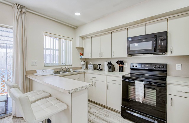 Gorgeous & sun-soaked oasis with pool, furnished patio, generous yard, & AC