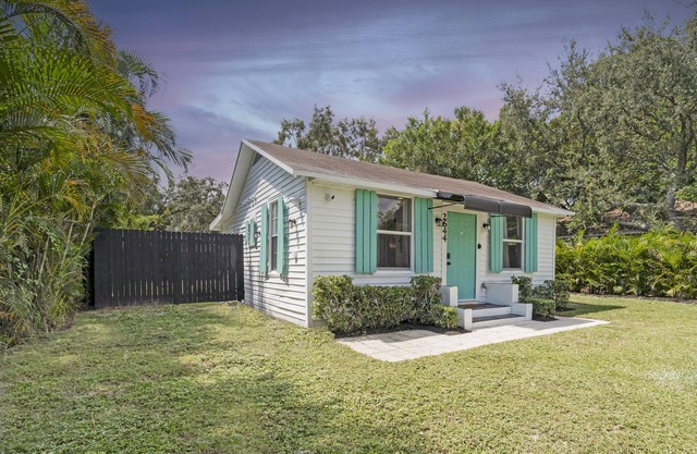 House with Fenced Yard - Palm Wave Says -