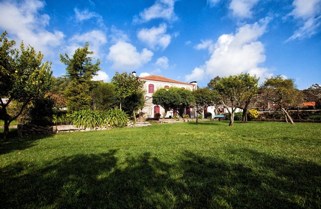 House with pool and surrounded by extensive gardens, situated on a hill, sea view