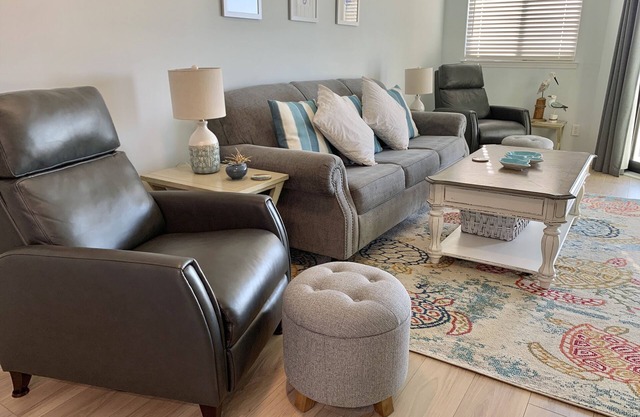 Inviting waterfront condo with marsh view, pool, balcony, central AC, & W/D
