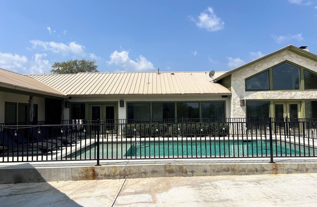 Large home with a pool sitting on the tee of the first tee box