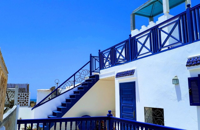 Large sunny riad under the open sky in the medina near the skala and the port.