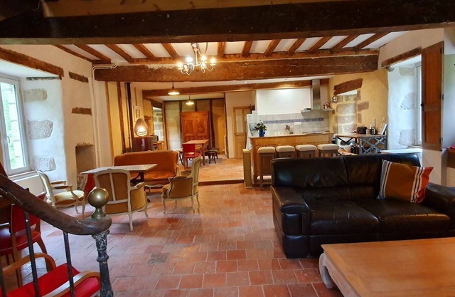 Le moulin l'official, on the banks of the river in a peaceful natural setting,
