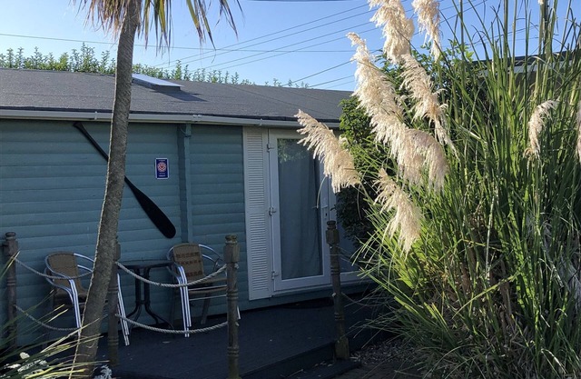 Log Cabin next to our sandy beach with lovely sea views, close Norfolk Broads.