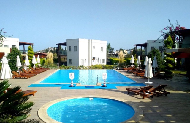 Luxury 3 bedroom holiday villa with communal swimming pool.