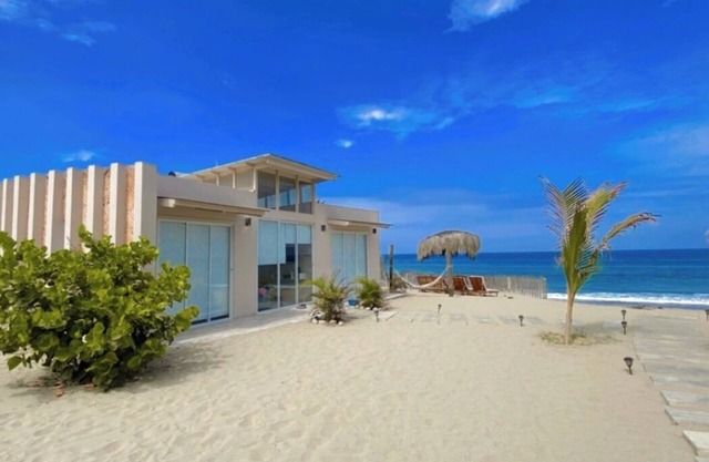 Nice bungalow on the beach, in front of the warm and calm sea.