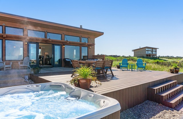 Oceanfront beach home with private hot tub, ocean views, & free WiFi