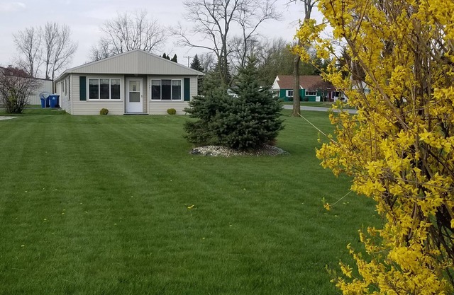 Open concept 2 bedroom ranch with attached garage and deck