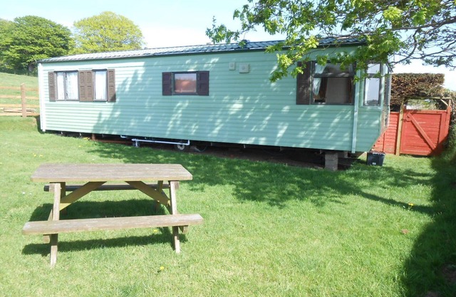 Peaceful caravan with WiFi in charming outskirts Callington on a working farm .