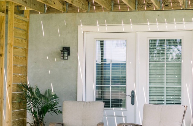 Private suite with kitchenette, bedroom, bathroom and patio.