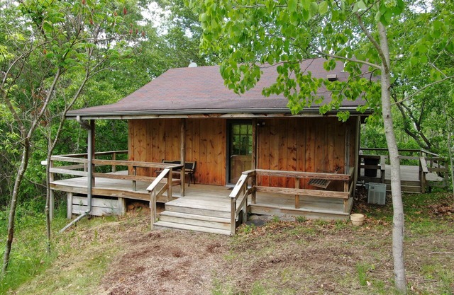 Quaint cabin overlooking the creek below and wetlands in the valley basin.