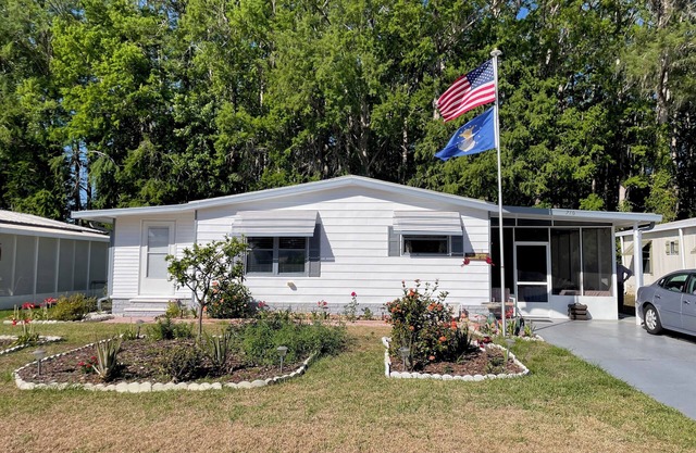 Relax in style—lanai, golf cart & tranquil wooded views included!