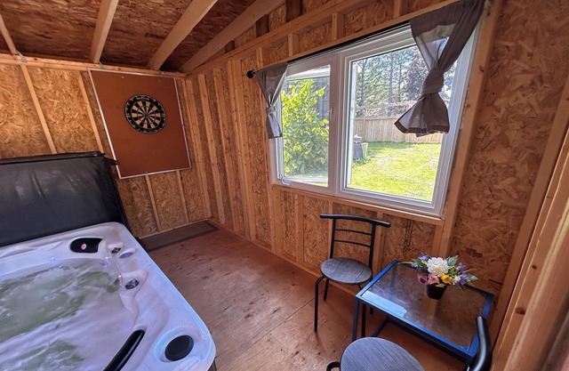 Relax with an enclosed hot tub and cozy island vibes in the heart of Summerside