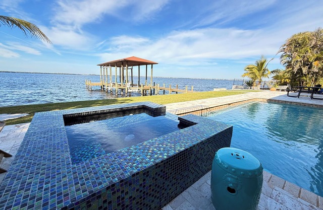 Riverfront 5 bedrooms, 5 baths , pool , spa , beach , dock and stunning views !