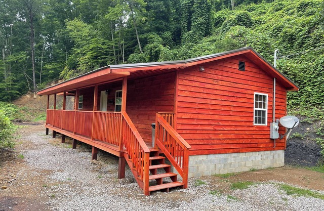 Secluded Cabin with a mountain view, hot tub, full kitchen, and living room.