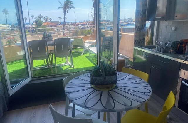 Studio with terrace overlooking sea, port and mountains.