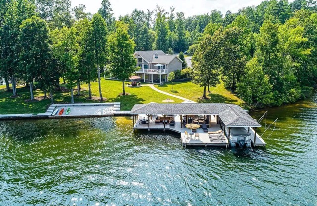 Stunning home w/sand beach, flat yard for games, dock w/living area and bar!