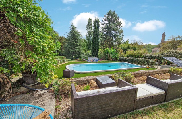 Stylish stone house with pool and wooded park.