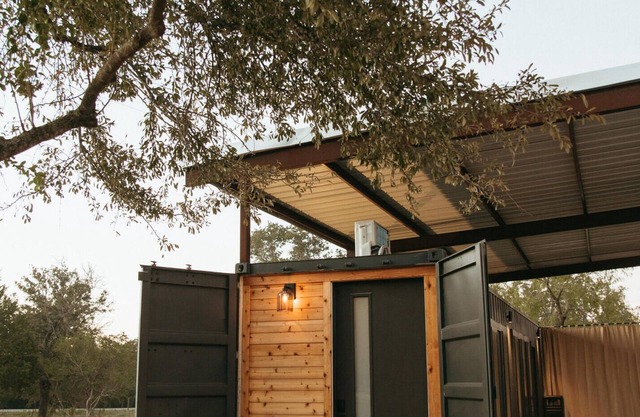 This home sits on a 45 acre, wooded retreat and event venue called Wild Roots Lockhart with tons of amenities including pickleball!