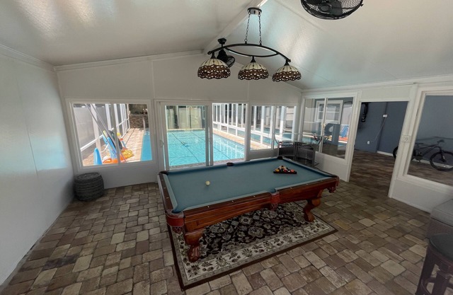 This house has swimming pool with water heater and parking for many cars.