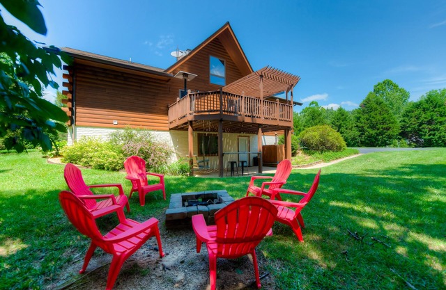 Three-story dog-friendly home with large deck, wood swing, firepit, lawn, & more