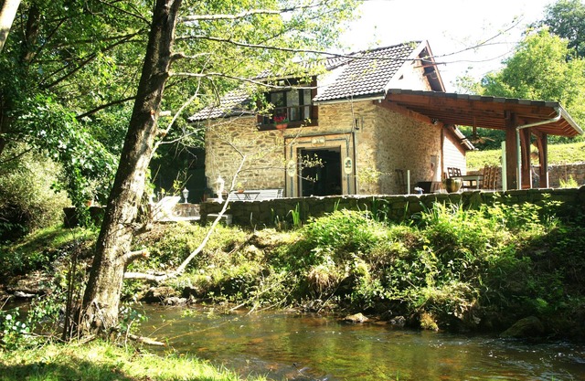 Twelfth-century mill in a green setting.