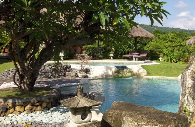 Typical Balinese villa with beautifully landscaped swimming pool