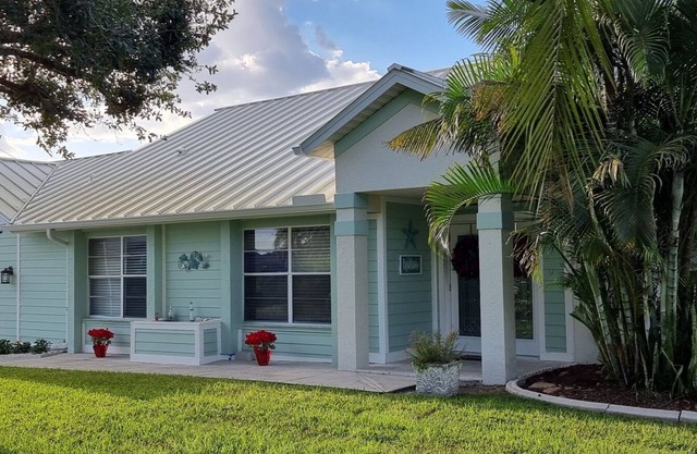 Villa Coral Cove heated pool, large lanai, lounge and fire pit in For Mile Cove