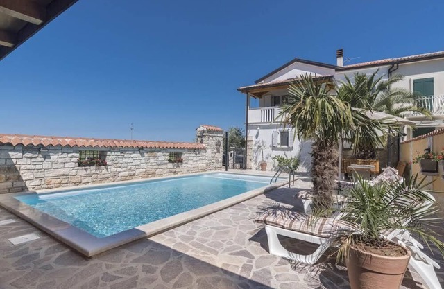 Villa with heated pool on the edge of an olive grove overlooking the sea