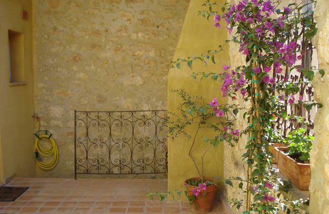Village house near the Mediterranean open onto its patio terrace.