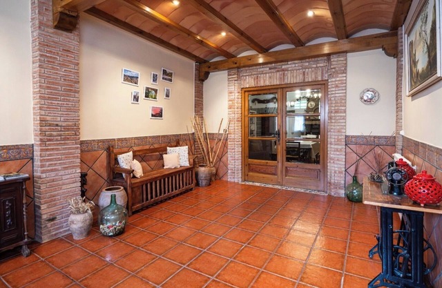 Village house with picnic area and fireplace.