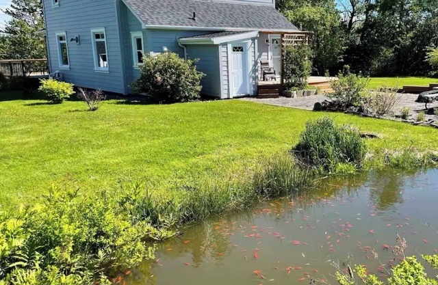 Waterfront homestead on 4 landscaped acres.