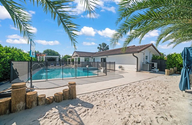 You'll be captivated by the stunning 28 x 40 custom heated pool with jacuzzi