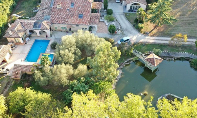 Montpouillan House | A bucolic stone estate with a cascading pool.