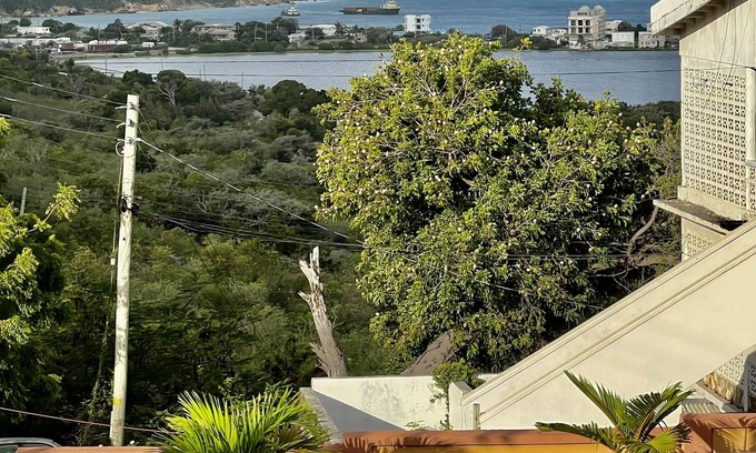 The Valley Apartment | A colored beacon sitting on the hill side road that leads into Sandy Ground,