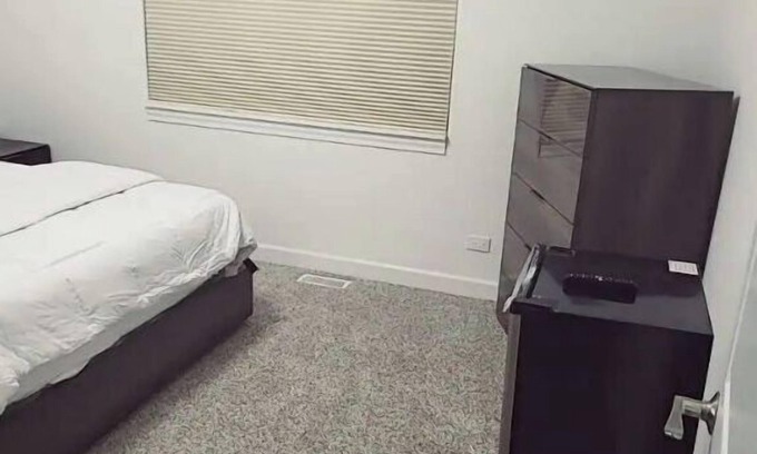 Oak Lawn House | A cozy bedroom in a home with high-tech amenities