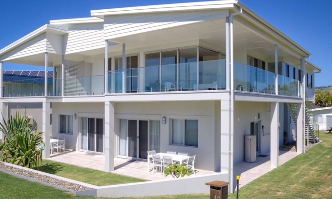 Woolgoolga Apartment | Absolute beachfront location, king size bed to relax and recover.Lock up garage
