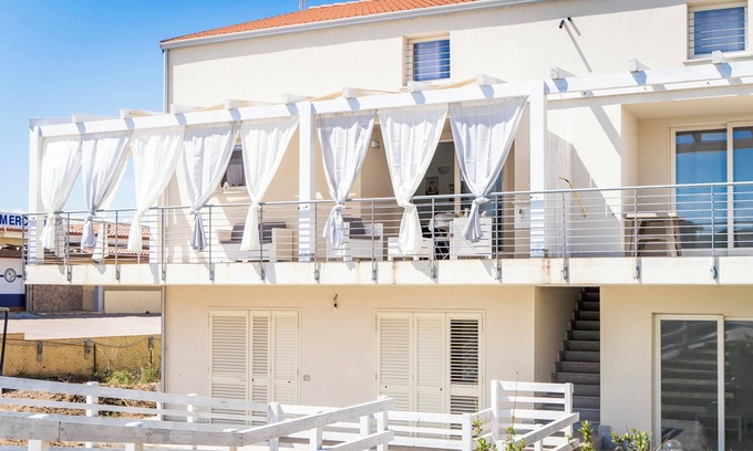 Trinita d'Agultu e Vignola Apartment | Apartment "Ulivi 17" with Sea View, A/C, Terrace, Reserved Parking and Wi-Fi