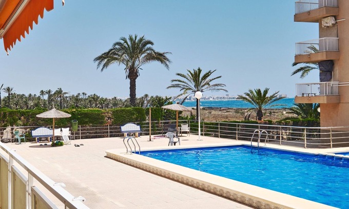 Punta Prima Apartment | Apartment with 2 bedrooms, Wi-Fi, air conditioning, sea view, pool, and garage