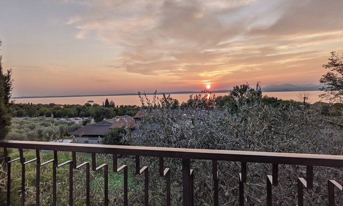 Cisano Apartment | Apartment with panoramic lake view, west-facing balcony, communal pool, 500m to the lake