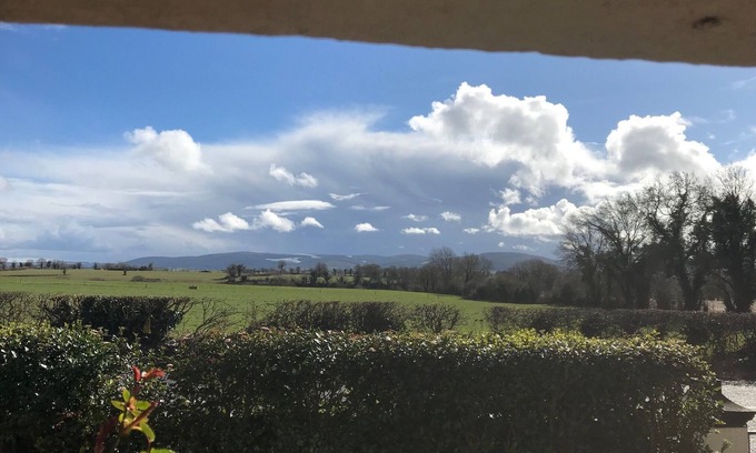 County Cork House | Ballygown Cottage with views across open countryside out to the mountains