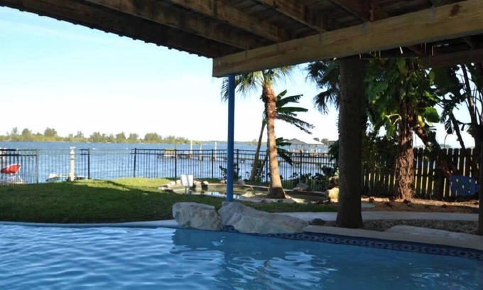 Grant-Valkaria Ski Chalet | Beautiful Riverfront Chalet w/Pool & Boat Dock- Old Florida Fun- Pet Friendly!