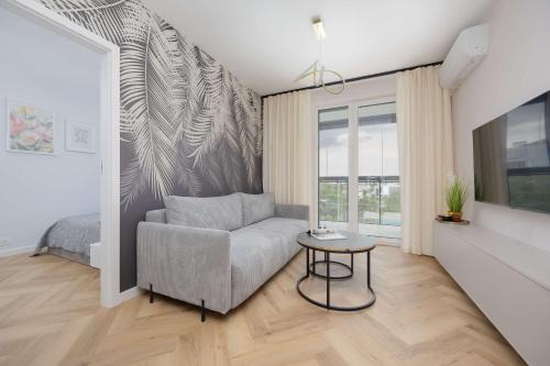 Wlochy Apartment | Beige Apartment in Warsaw with Parking and Air Conditioned Living Room by Noclegi Renters