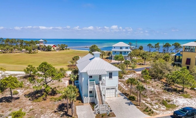 Cape San Blas House | Blue Pelican is a stunning bayfront retreat in the gated Ovation community at Cape San Blas, offering sweeping views of St. Joseph Bay and easy access to both the bay and Gulf.